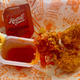 Hottie Sauce is thick, sticky, and neon orange, very on brand for Popeyes.